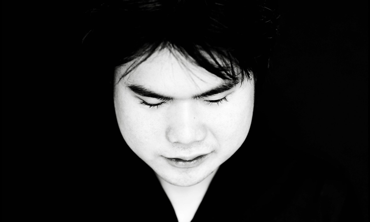 black and white photo of piano player face looking down